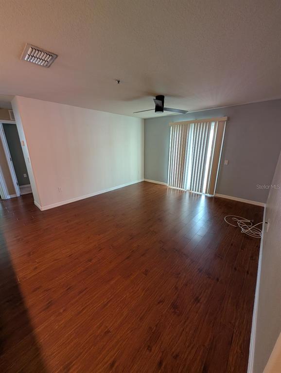 6394 Banyan Boulevard, Unit 204 New Port Richey, FL 34652 - Photo 10 of 25 a view of an empty room with wooden floor and a window