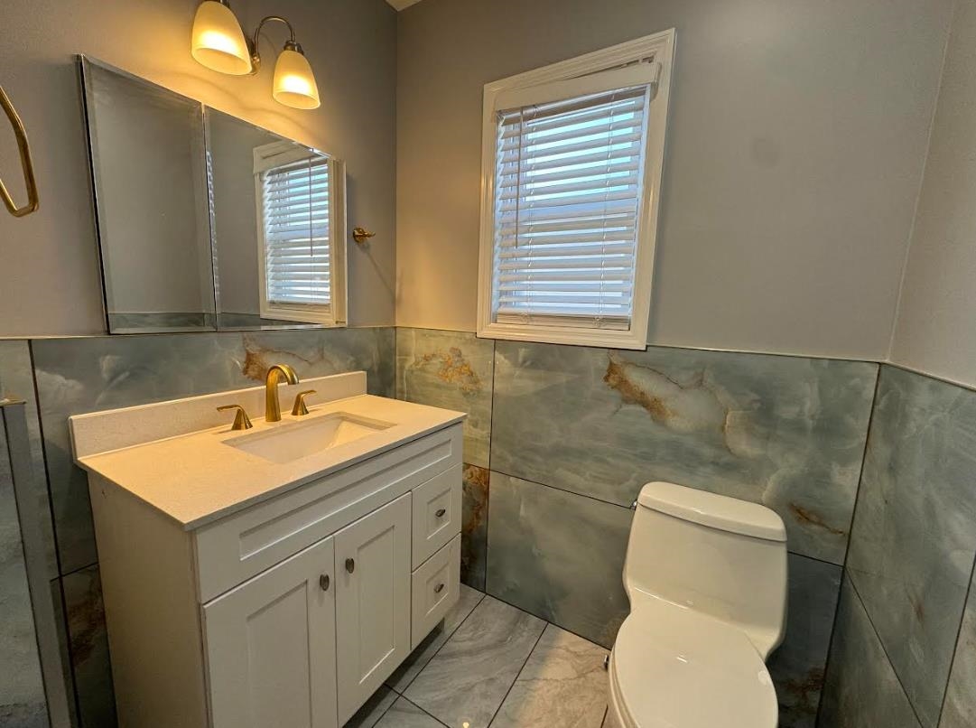 243 Hamilton Place, Unit 2 Hackensack, NJ 07601 - Photo 8 of 9 a bathroom with a sink toilet and mirror