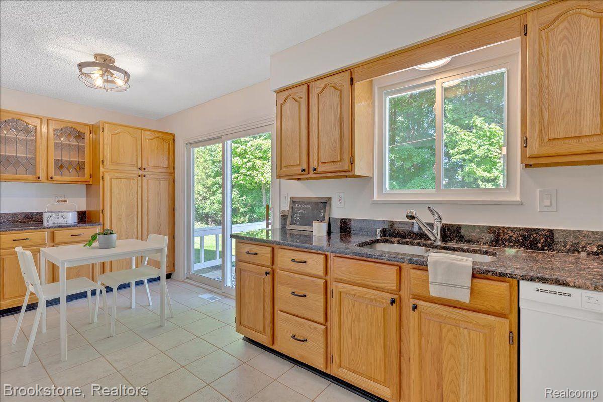 3265 Baldwin Road Metamora, MI 48455 - Photo 16 of 46 Large windows look onto woods and lake views