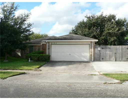 a front view of house with yard and trees