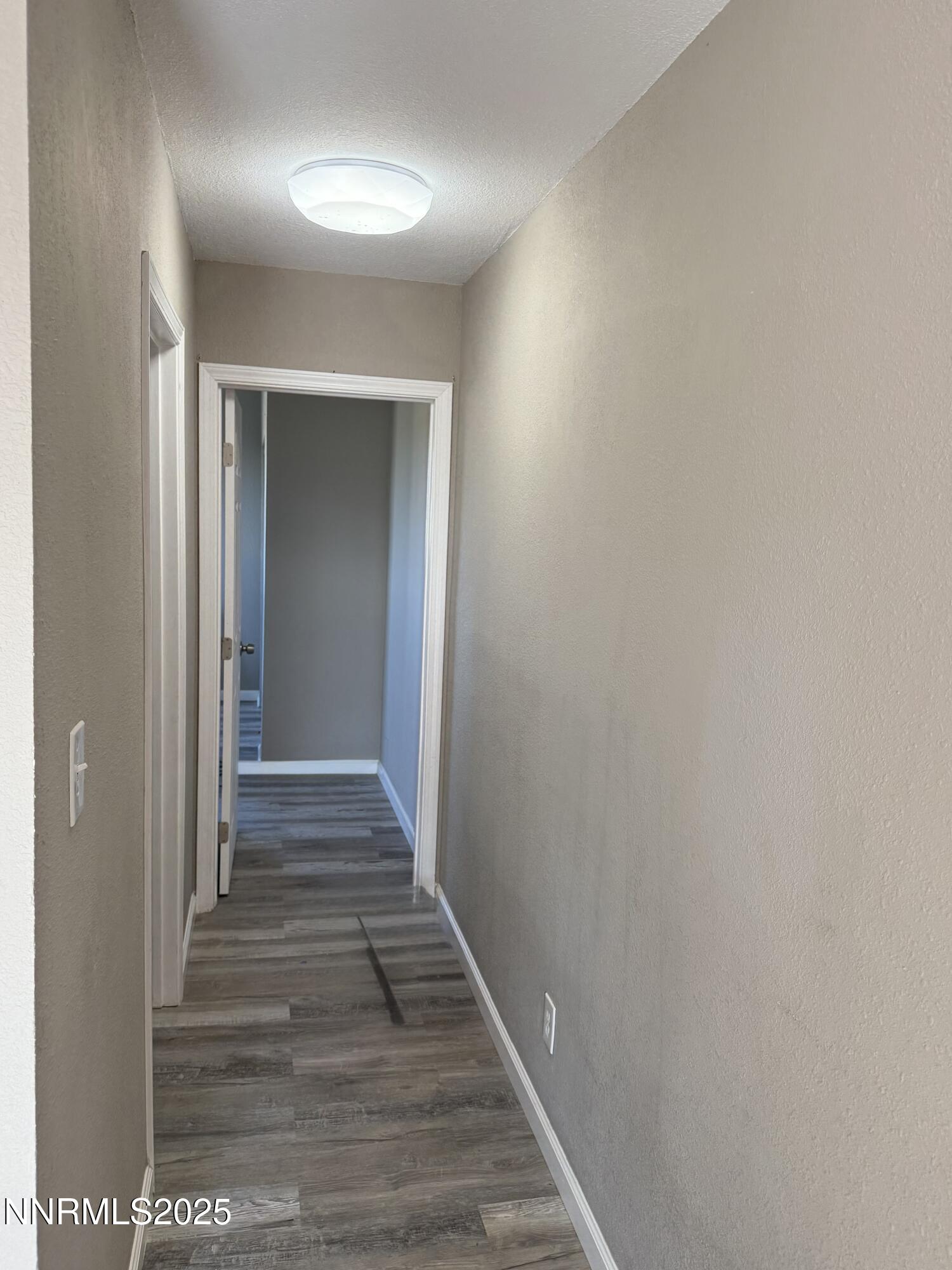 6722 Power Line Road Fallon, NV 89406 - Photo 12 of 15 a view of a hallway with wooden floor