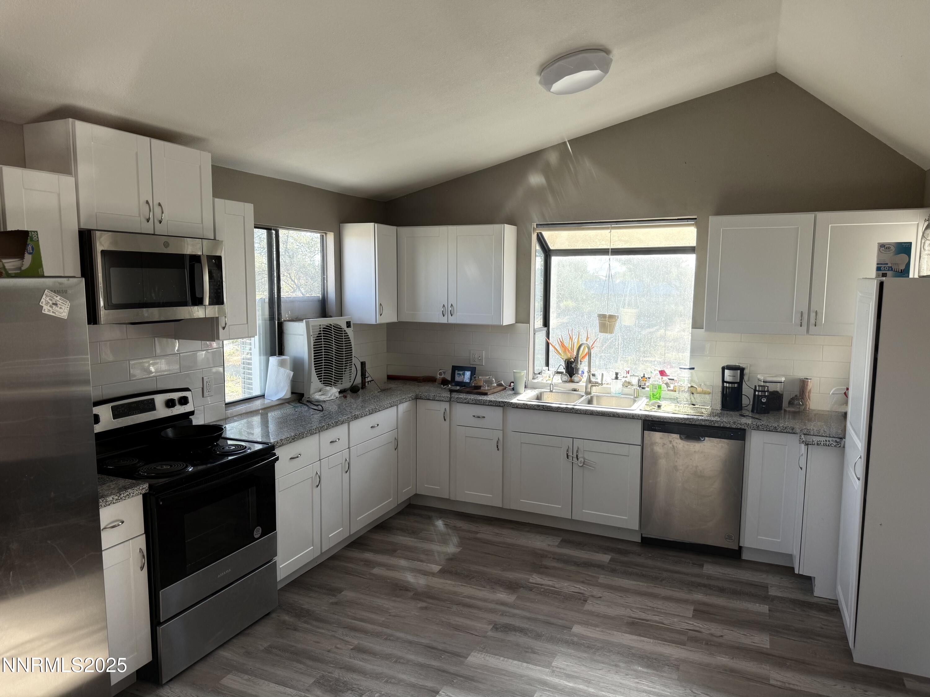 6722 Power Line Road Fallon, NV 89406 - Photo 6 of 15 a kitchen with granite countertop a refrigerator stove top oven and sink
