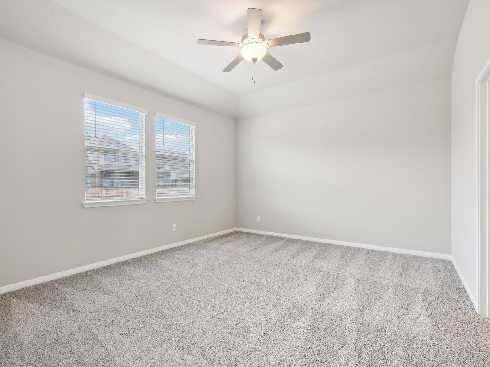 1812 South Main Street Kyle, TX 78640 - Photo 4 of 13 an empty room with windows and fan