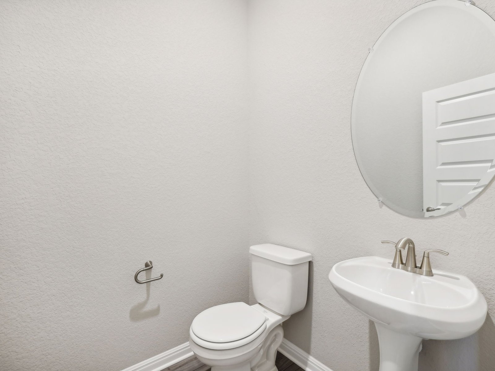 1812 South Main Street Kyle, TX 78640 - Photo 7 of 13 a bathroom with a sink a toilet and a mirror