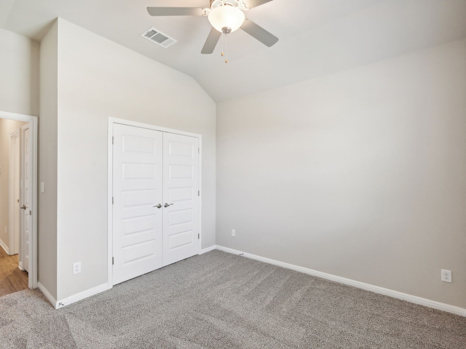 1812 South Main Street Kyle, TX 78640 - Photo 8 of 13 an empty room with a chandelier fan and closet