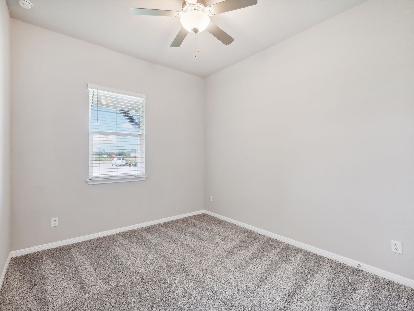 1812 South Main Street Kyle, TX 78640 - Photo 10 of 13 an empty room with a window and a fan