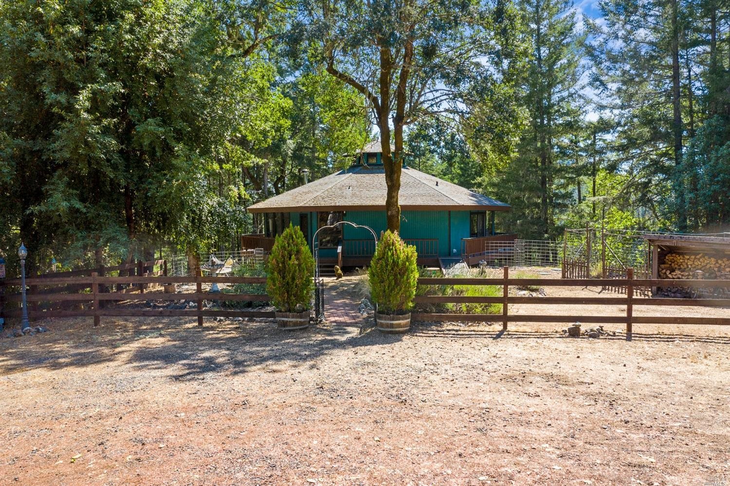 4200 Muir Mill Road Willits, CA 95490 - Photo 1 of 1 a view of a park that has a table and chairs under an umbrella