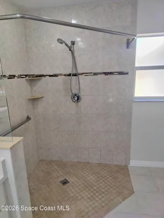 a bathroom with a sink a toilet and a shower