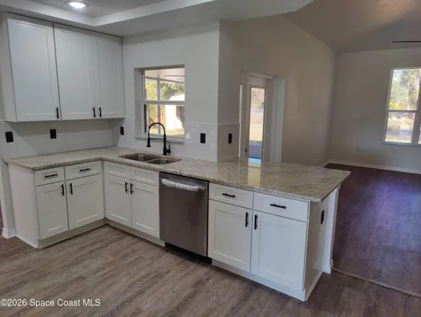 a kitchen with a stove a microwave and a refrigerator