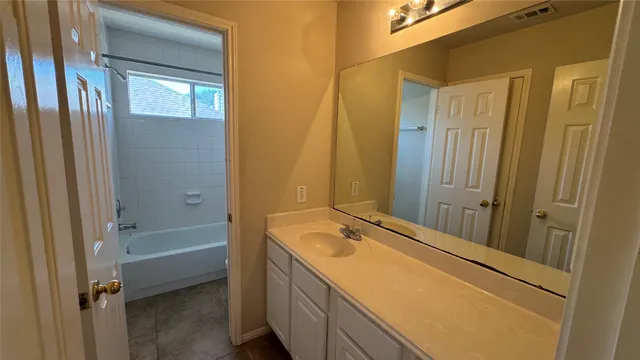 a bathroom with a tub and a sink