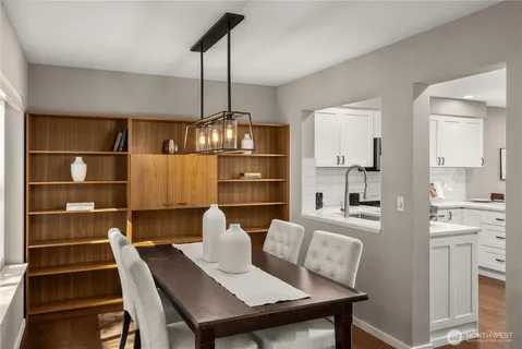 a view of a dining room with furniture wooden floor and chandelier