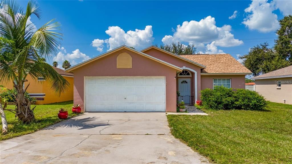 871 Reflections Loop East Winter Haven, FL 33884 - Photo 10 of 23 a front view of a house with a yard and potted plants