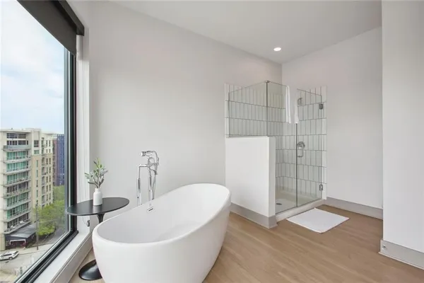a bathroom with a bathtub and shower