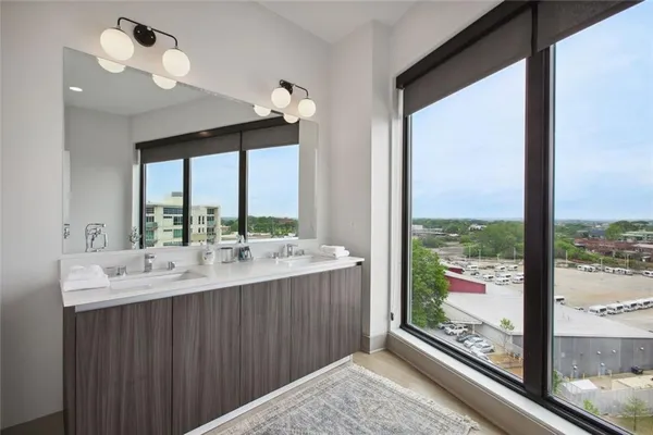 a bathroom with a double vanity sink and a large mirror