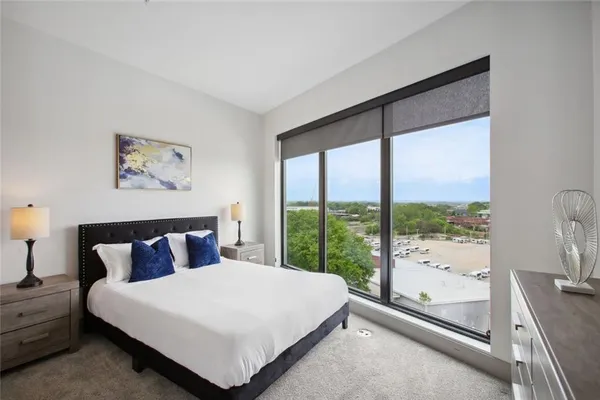 a bedroom with a large bed and a large window