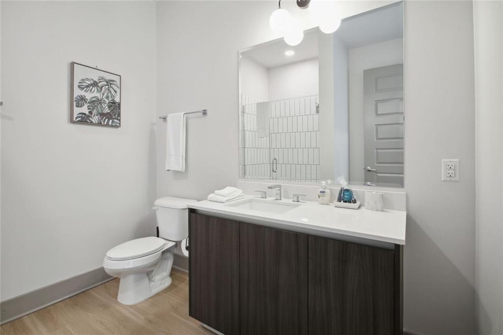 1050 Howell Mill Road, Unit 2 Atlanta, GA 30318 - Photo 10 of 17 a bathroom with a toilet a sink and mirror