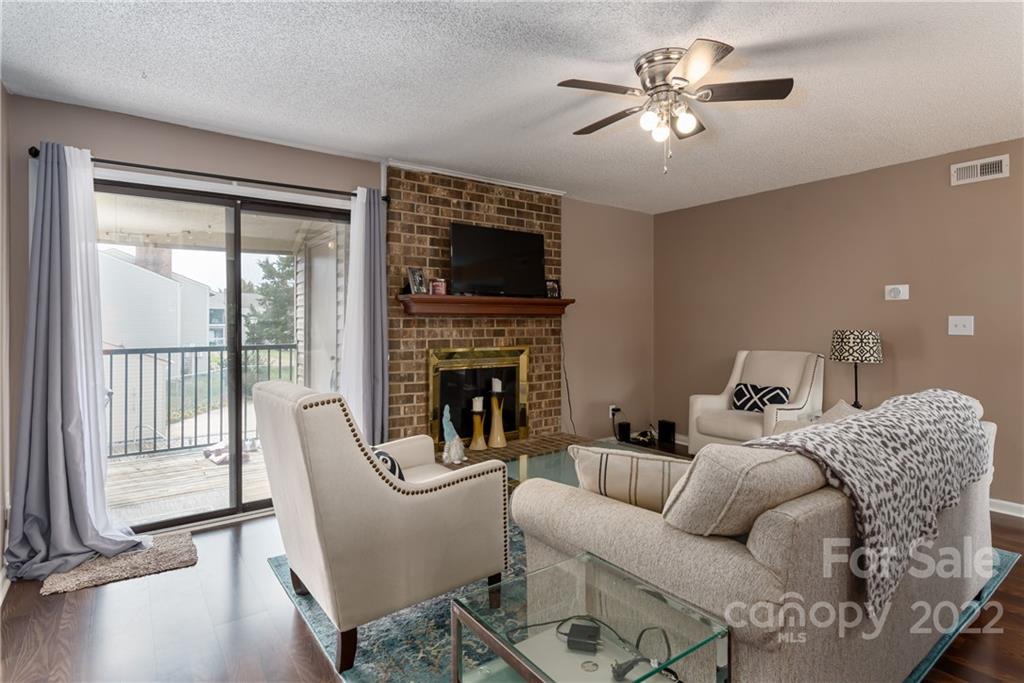 11054 Running Ridge Road Charlotte, NC 28226 - Photo 12 of 22 a living room with furniture a flat screen tv and a fireplace