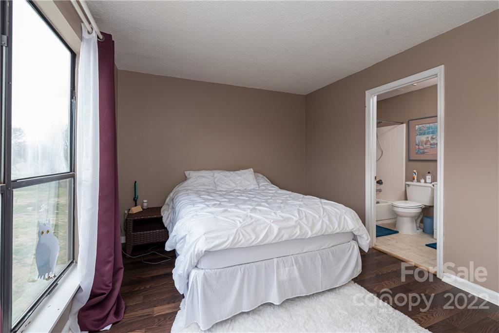 11054 Running Ridge Road Charlotte, NC 28226 - Photo 16 of 22 a bedroom with a bed and wooden floor