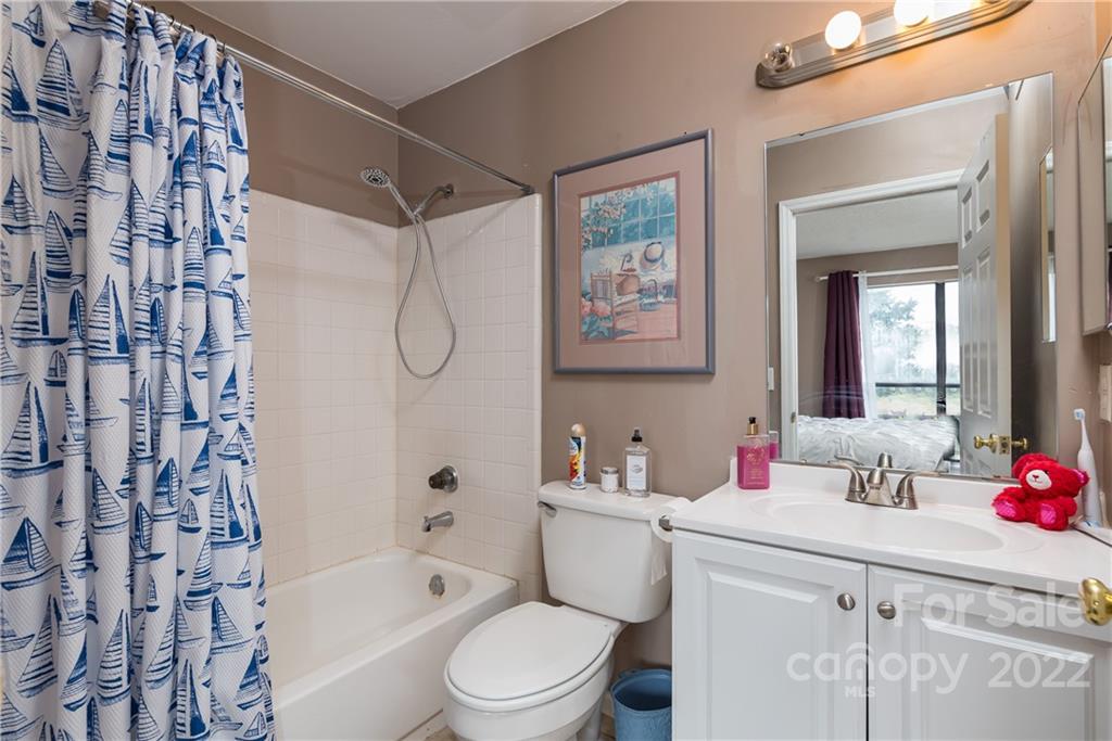 11054 Running Ridge Road Charlotte, NC 28226 - Photo 18 of 22 a bathroom with a toilet sink vanity tub and shower