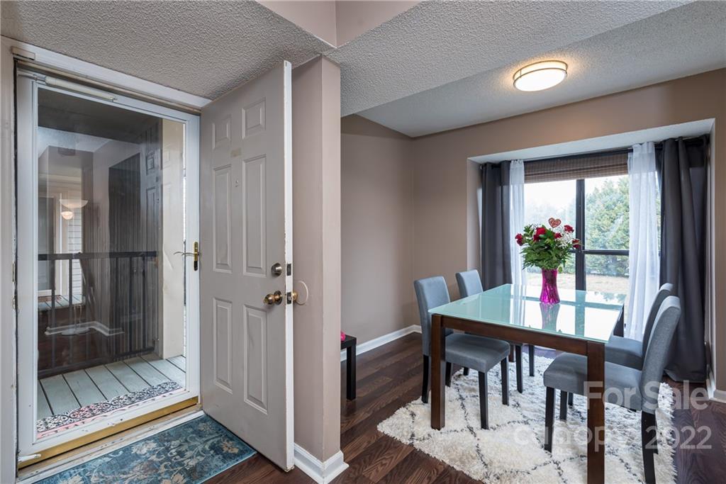 11054 Running Ridge Road Charlotte, NC 28226 - Photo 2 of 22 a view of a dining room with furniture window and wooden floor