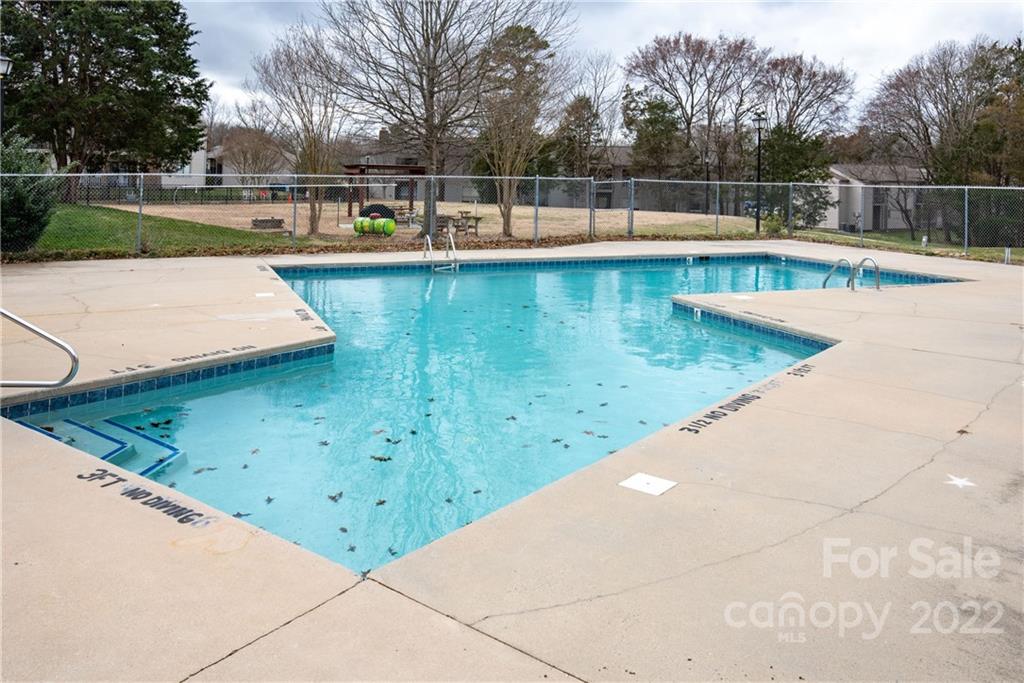 11054 Running Ridge Road Charlotte, NC 28226 - Photo 21 of 22 a view of a swimming pool with a yard