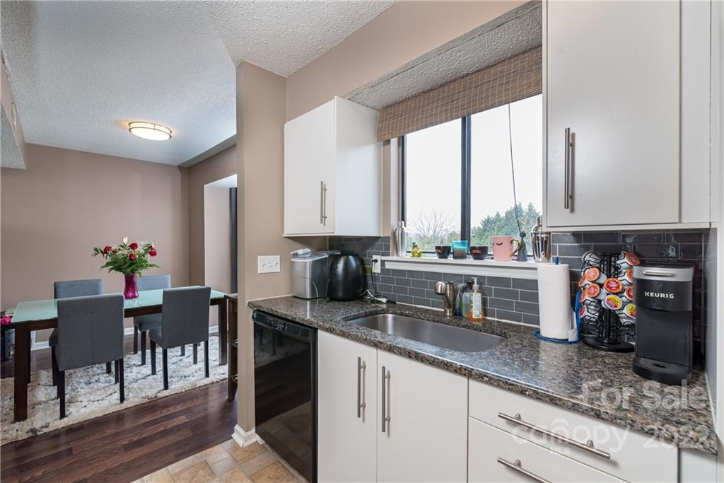 11054 Running Ridge Road Charlotte, NC 28226 - Photo 4 of 22 a kitchen with sink a window and chairs