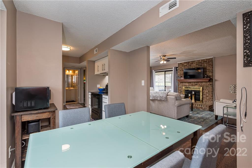 11054 Running Ridge Road Charlotte, NC 28226 - Photo 7 of 22 a living room with stainless steel appliances furniture and a flat screen tv