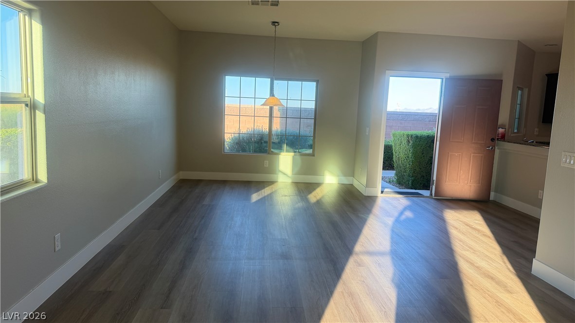 9453 Alma Ridge Avenue Las Vegas, NV 89178 - Photo 5 of 25 Sun-kissed interiors welcome you to a versatile dining area, featuring attractive wood flooring.