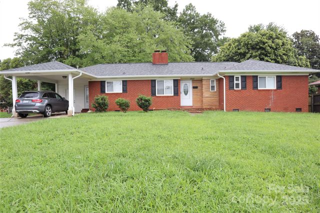 a front view of a house with a garden and yard