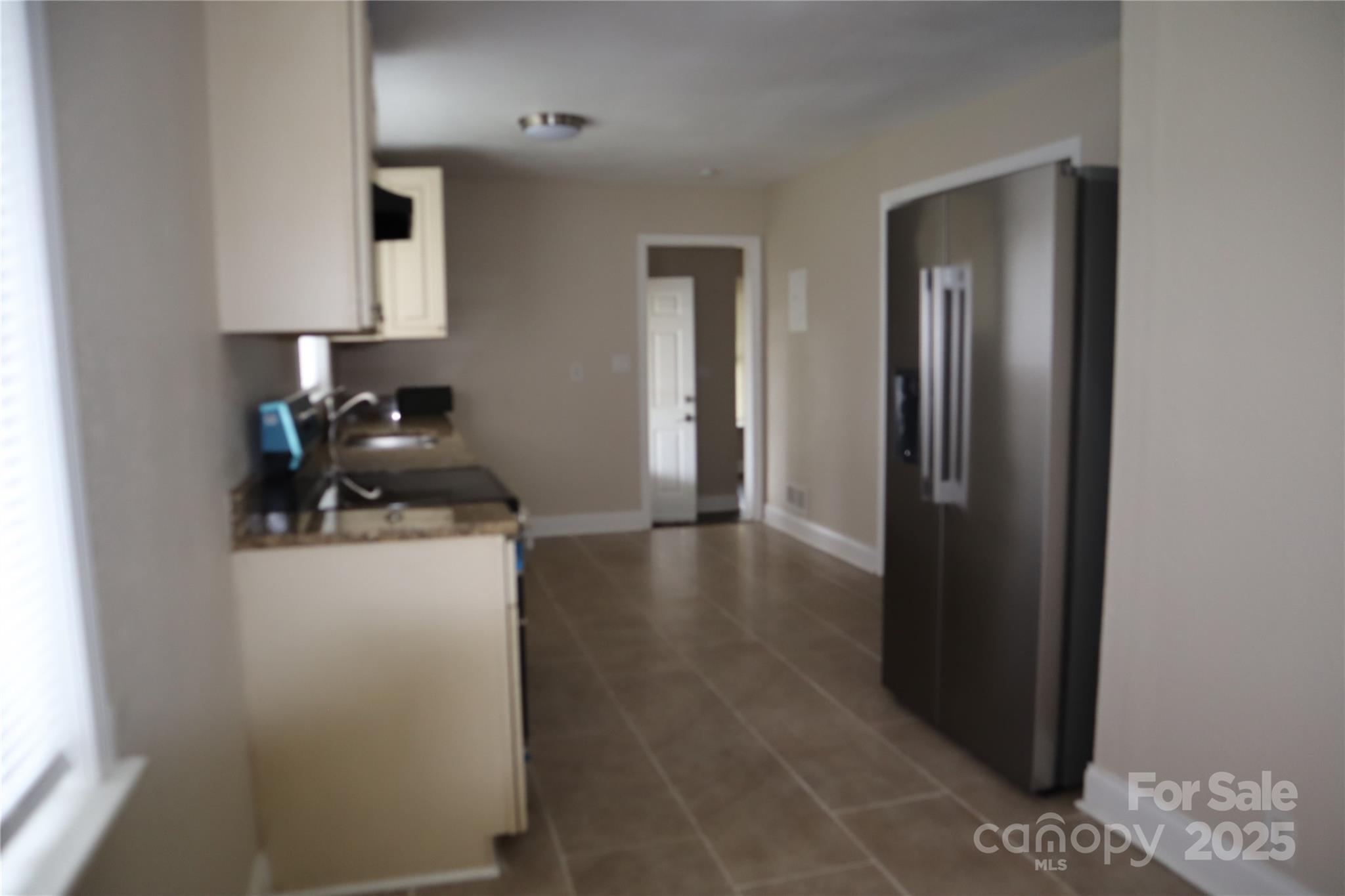 1703 Tyvola Road Charlotte, NC 28210 - Photo 14 of 17 a kitchen with stainless steel appliances a refrigerator and a stove