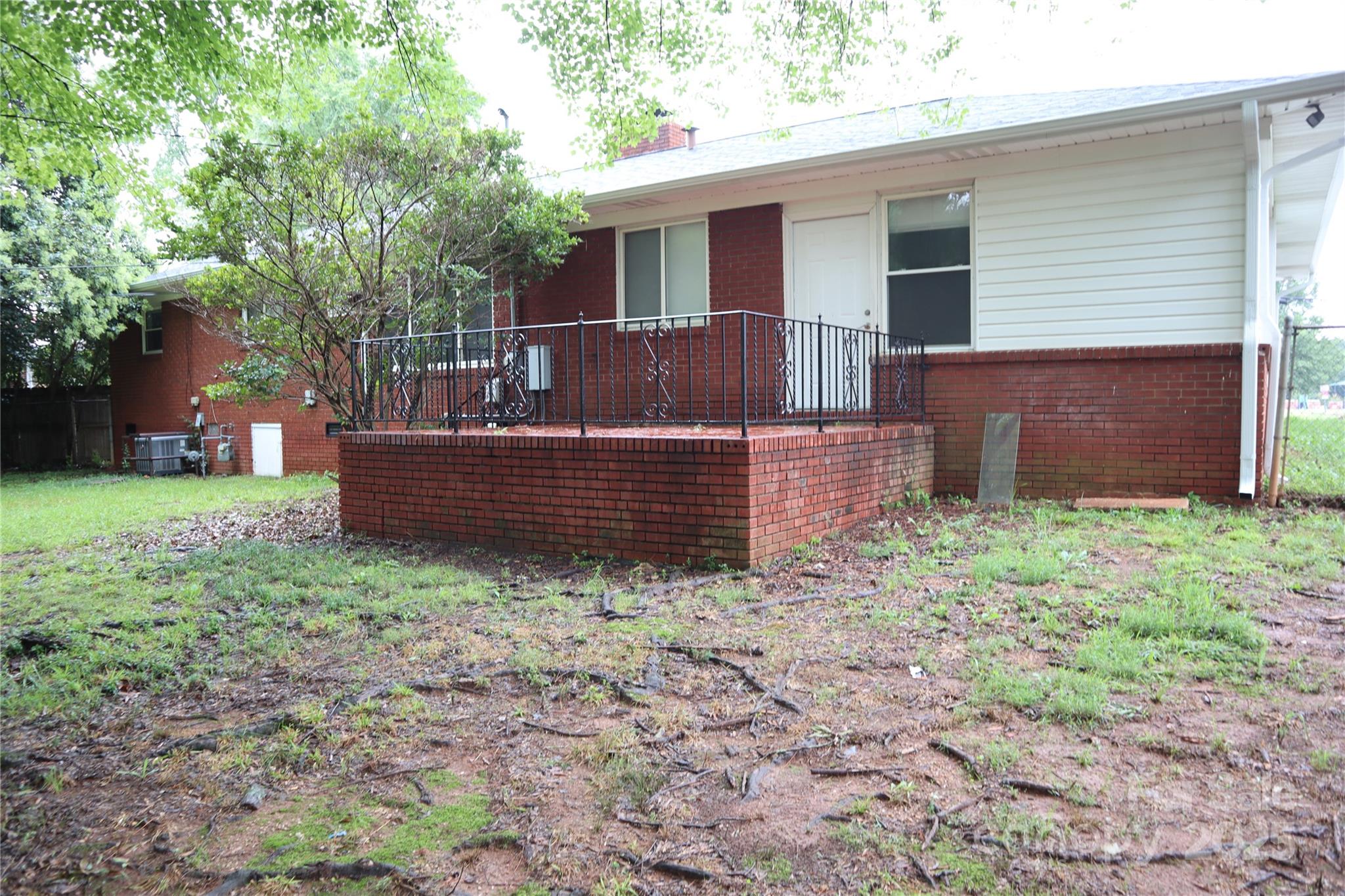 1703 Tyvola Road Charlotte, NC 28210 - Photo 2 of 17 a front view of a house with garden