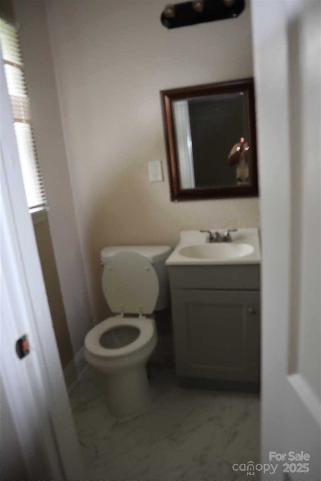 1703 Tyvola Road Charlotte, NC 28210 - Photo 9 of 17 a bathroom with a toilet sink and mirror