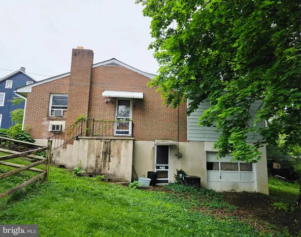 a front view of a house with a garden and yard