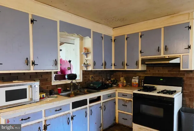 a kitchen with cabinets and appliances