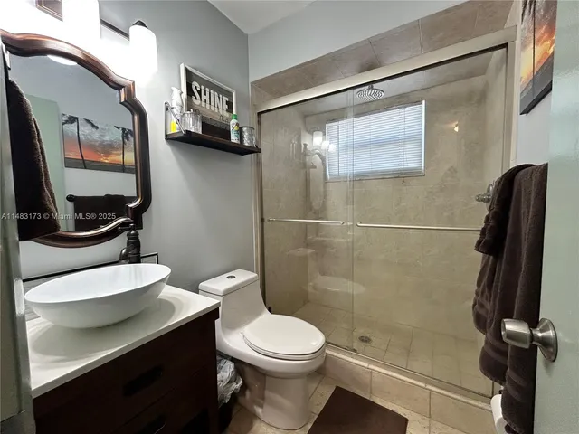 a bathroom with a toilet a sink and shower