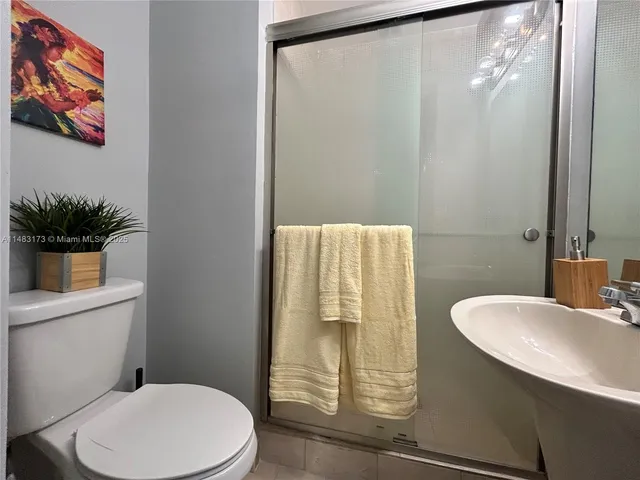 a white toilet sitting next to a bath tub
