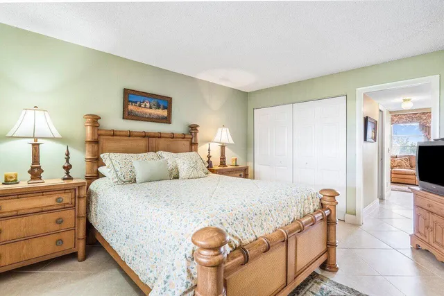 a bedroom with a bed and a lamp on table