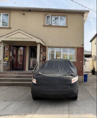 a front view of a house with a garden