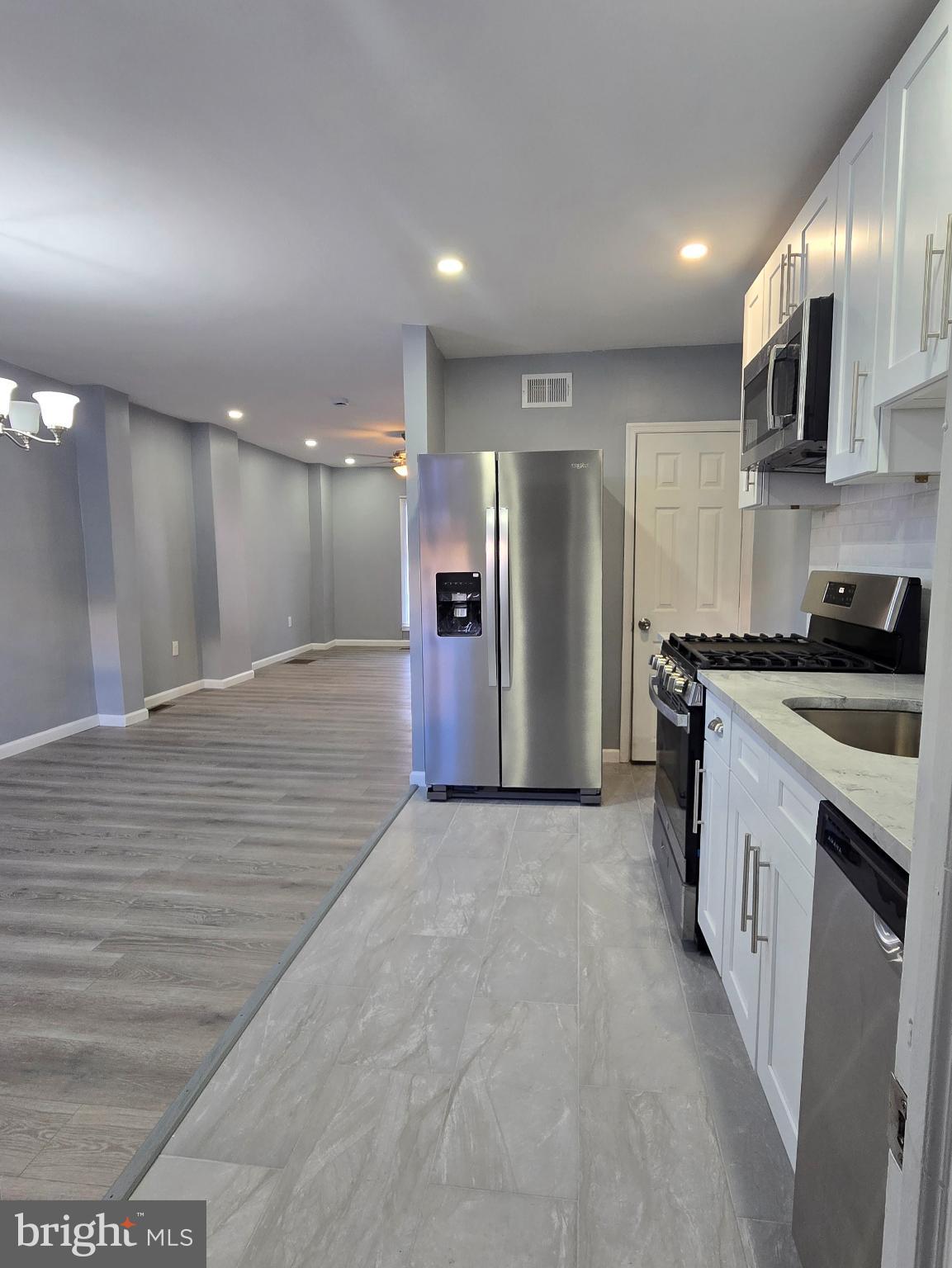 6733 Linmore Avenue Philadelphia, PA 19142 - Photo 16 of 55 a kitchen with stainless steel appliances granite countertop a refrigerator and a sink