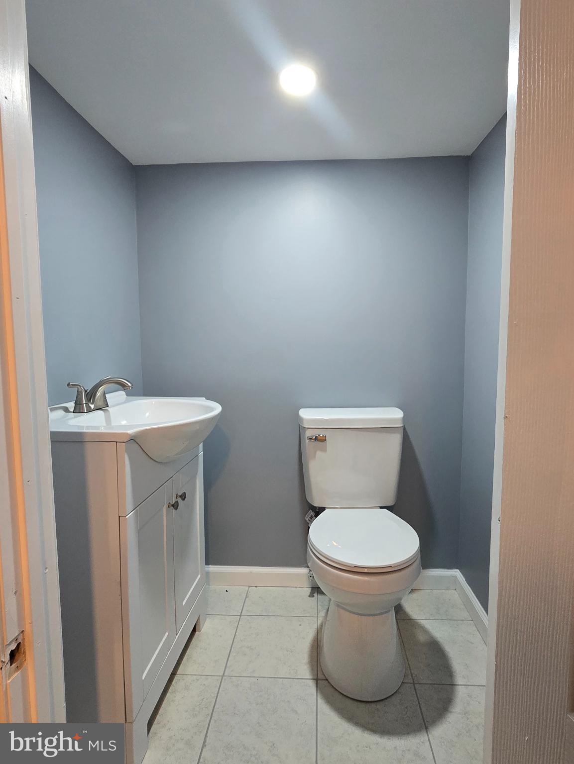 6733 Linmore Avenue Philadelphia, PA 19142 - Photo 19 of 55 a bathroom with a sink toilet and a mirror