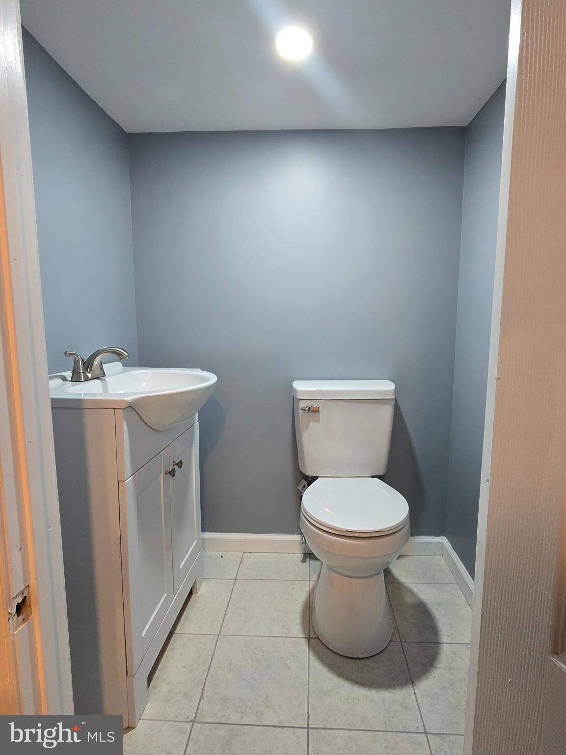 6733 Linmore Avenue Philadelphia, PA 19142 - Photo 20 of 55 a bathroom with a toilet sink and mirror
