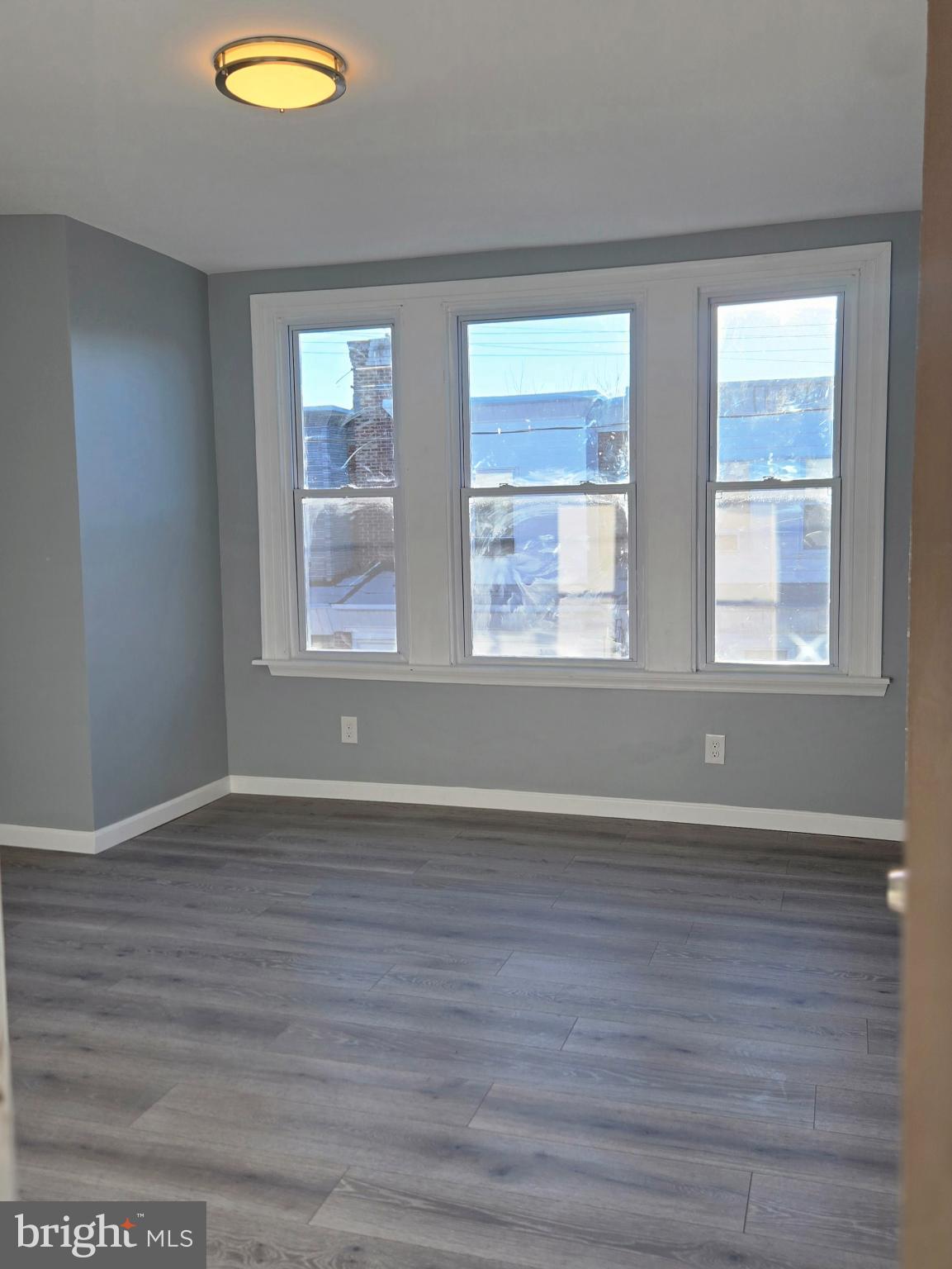 6733 Linmore Avenue Philadelphia, PA 19142 - Photo 24 of 55 a view of an empty room with wooden floor and a window