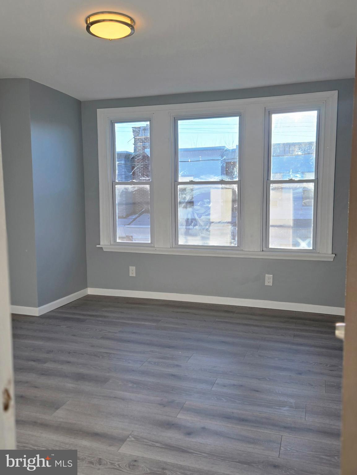 6733 Linmore Avenue Philadelphia, PA 19142 - Photo 25 of 55 a view of an empty room with wooden floor and a window