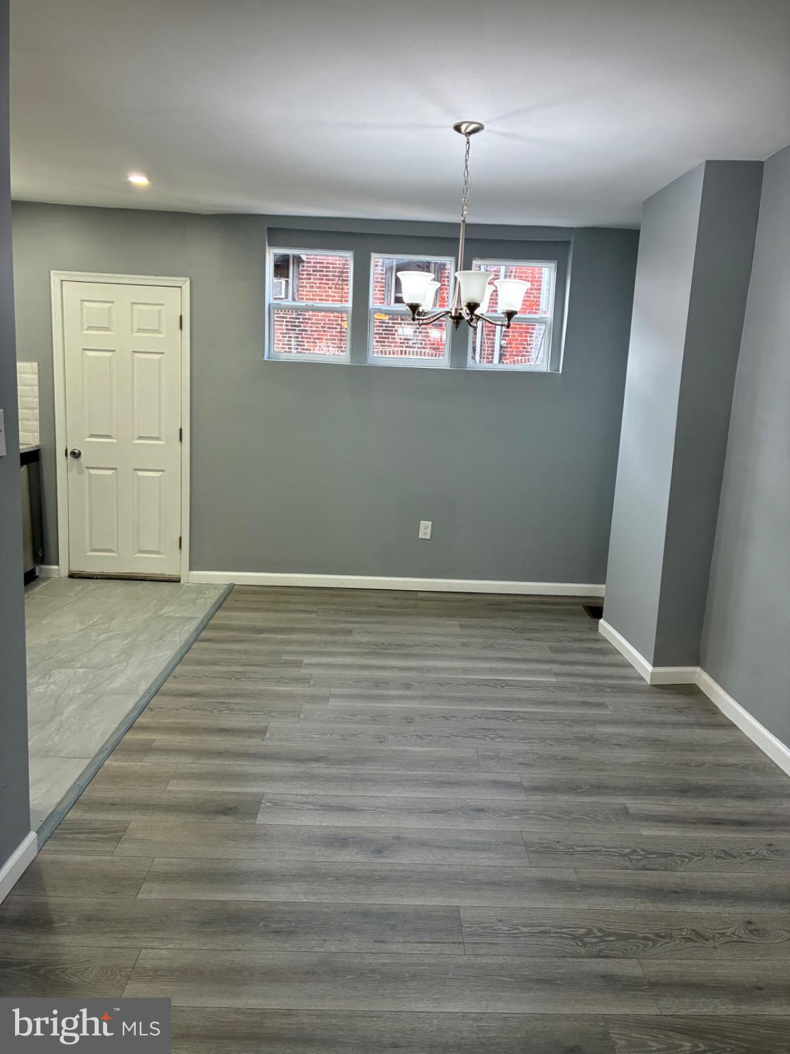 6733 Linmore Avenue Philadelphia, PA 19142 - Photo 33 of 55 an empty room with wooden floor and windows
