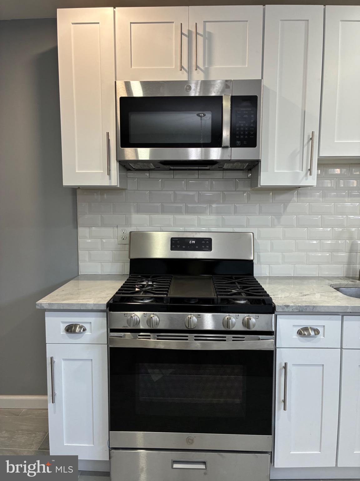 6733 Linmore Avenue Philadelphia, PA 19142 - Photo 38 of 55 a stove top oven sitting inside of a kitchen