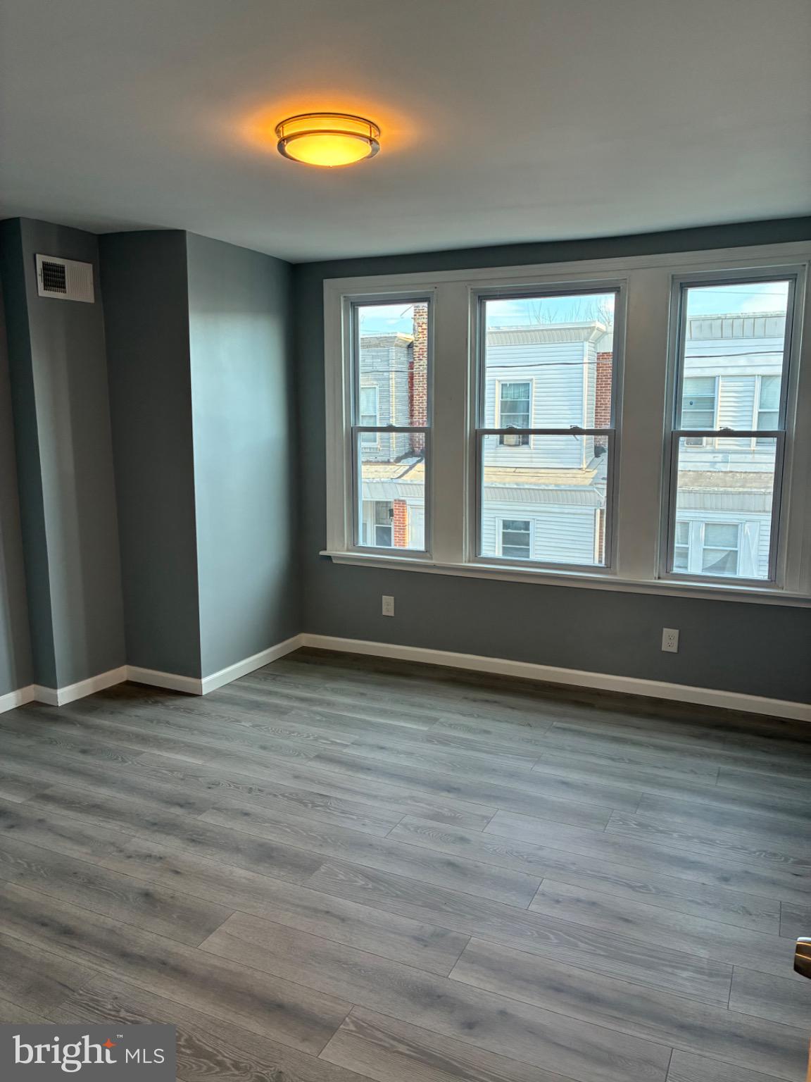 6733 Linmore Avenue Philadelphia, PA 19142 - Photo 43 of 55 a view of an empty room with wooden floor and a window