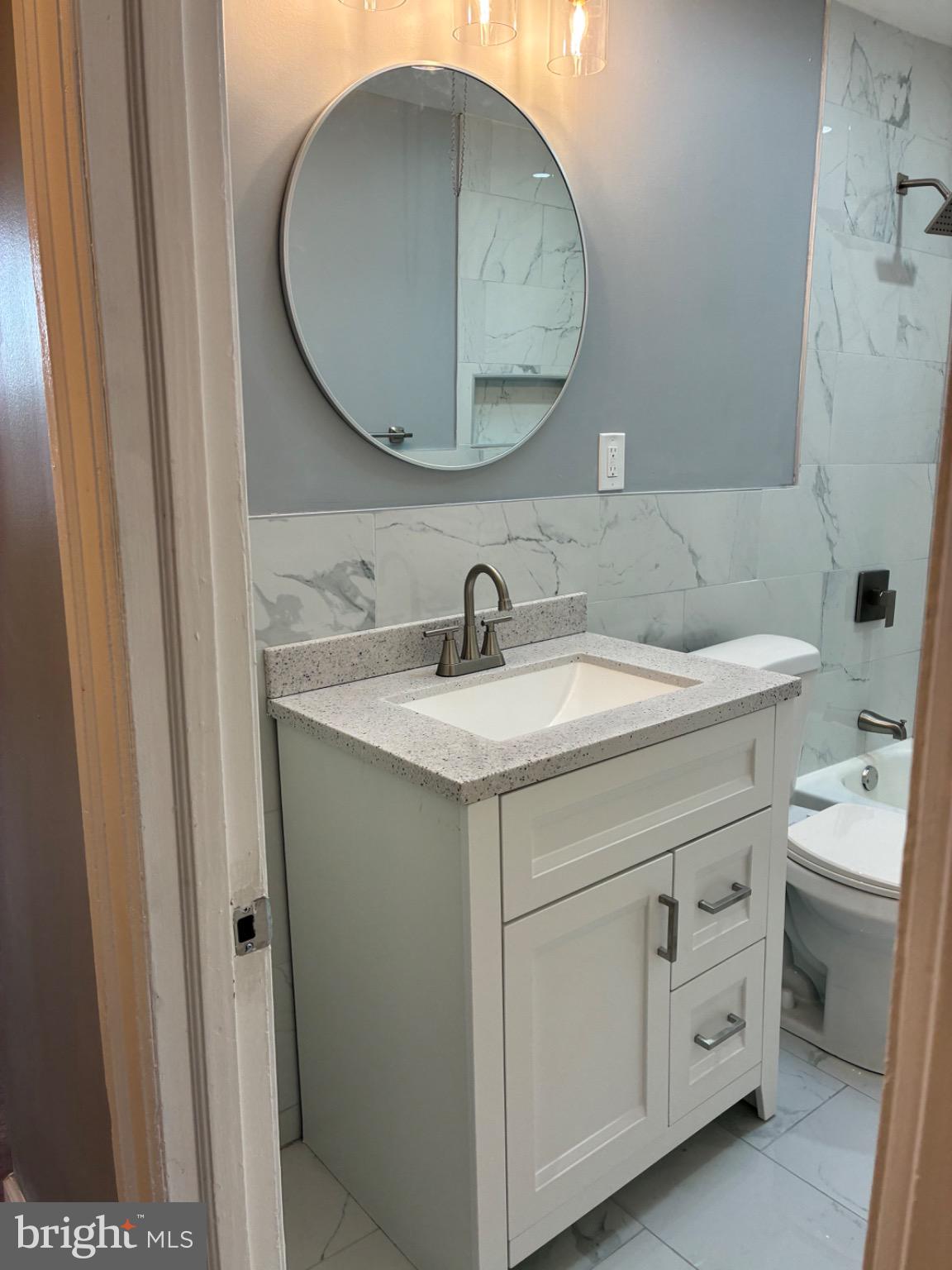 6733 Linmore Avenue Philadelphia, PA 19142 - Photo 49 of 55 a bathroom with a sink and a mirror