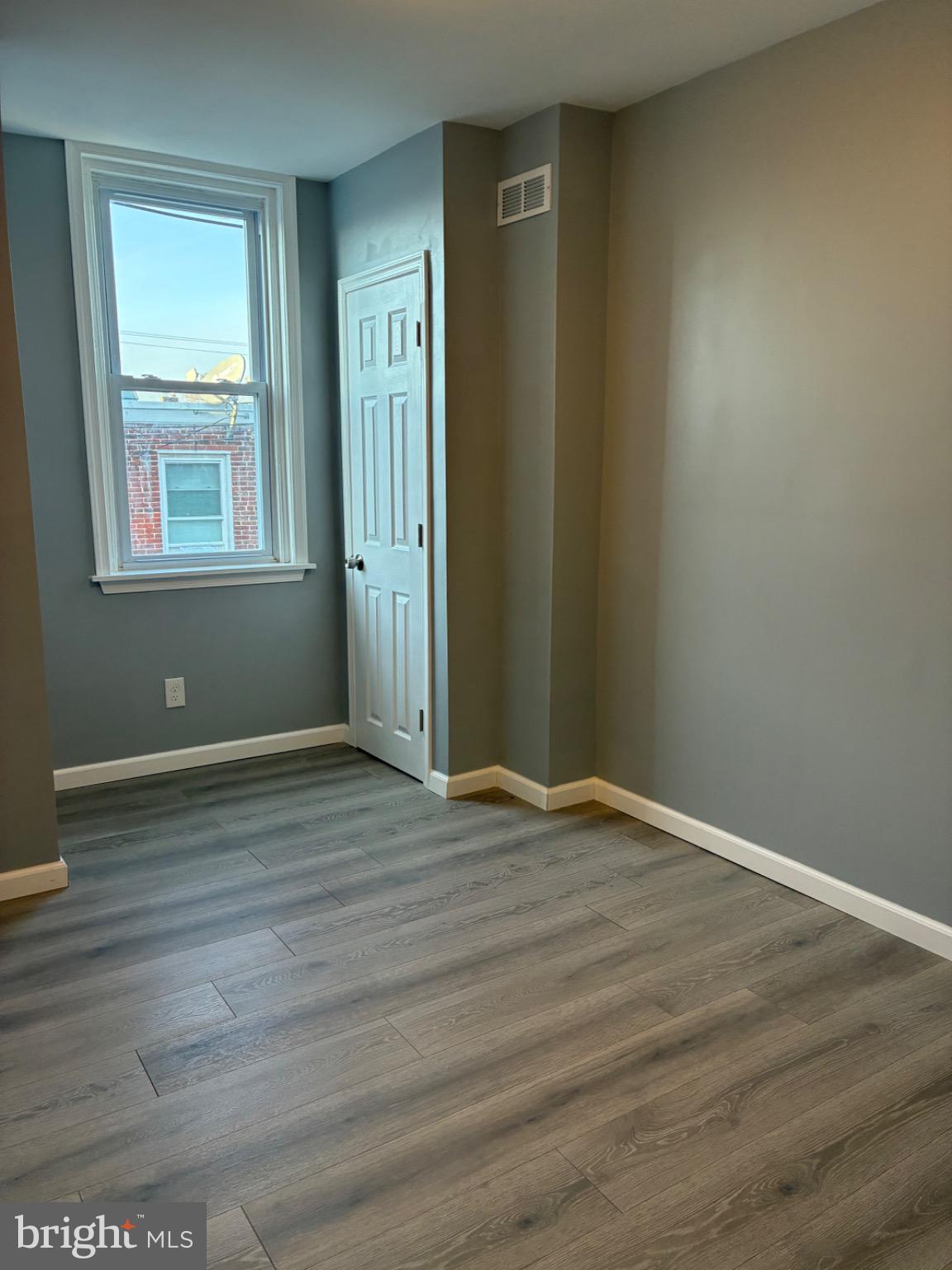 6733 Linmore Avenue Philadelphia, PA 19142 - Photo 52 of 55 a view of an empty room with wooden floor and a window