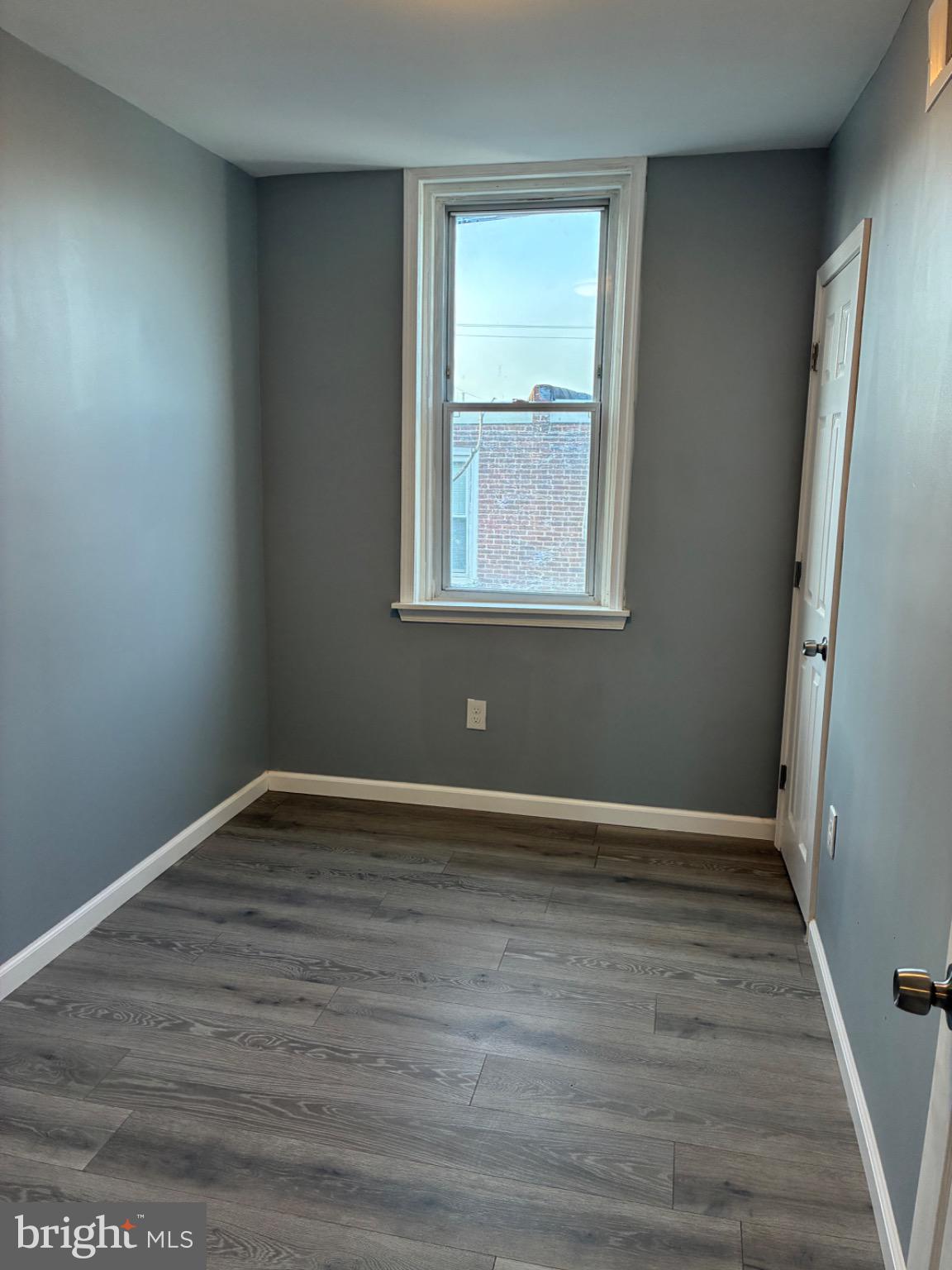 6733 Linmore Avenue Philadelphia, PA 19142 - Photo 53 of 55 a view of an empty room with wooden floor and a window