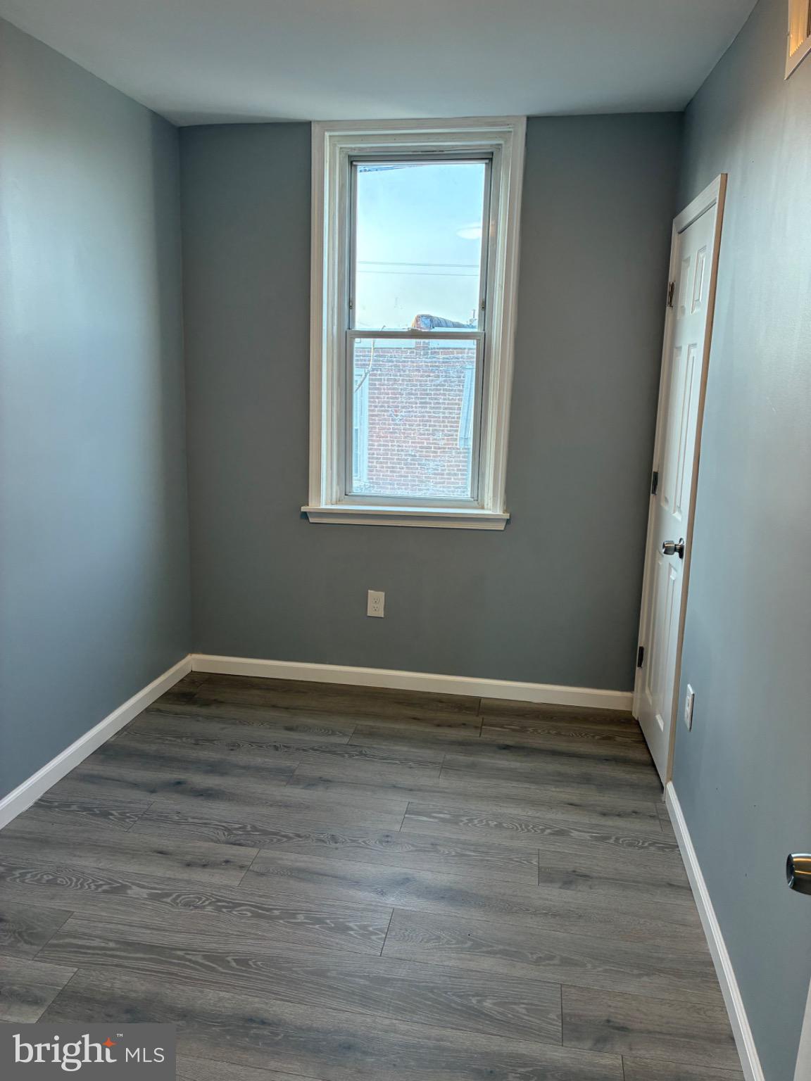 6733 Linmore Avenue Philadelphia, PA 19142 - Photo 54 of 55 a view of an empty room with wooden floor and a window